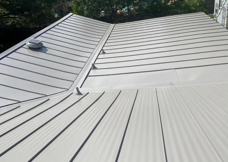Solar attic fan installed on a metal roof for Roof Ventilation in Gantt